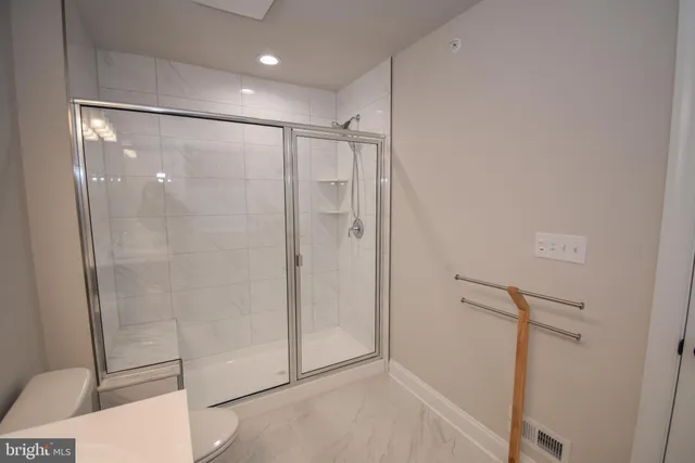 a bathroom with a shower and a glass door