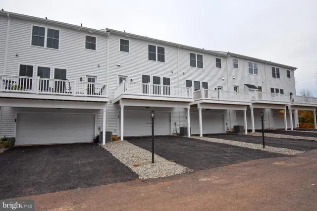 a sign broad in front of red brick house