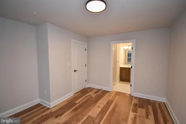 a view of a room with wooden floor and bathroom