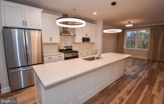 a kitchen with stainless steel appliances a refrigerator and a stove
