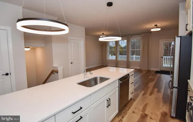 a kitchen with a sink and chandelier