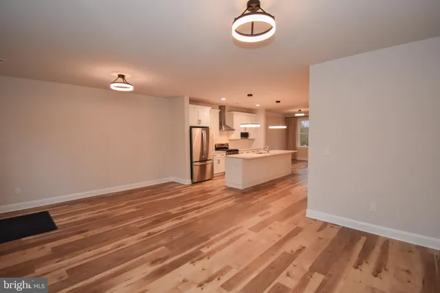 a view of a kitchen with wooden floor