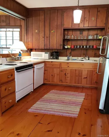 a spacious bathroom with stainless steel appliances granite countertop a sink and cabinets