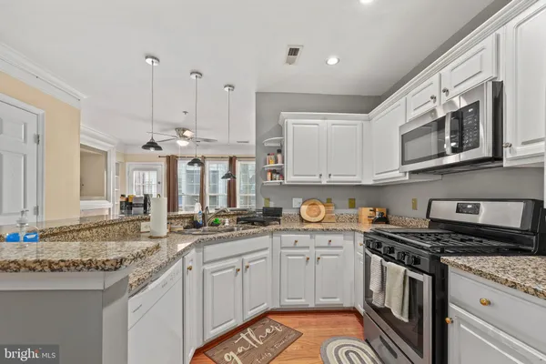 a kitchen with stainless steel appliances granite countertop a stove and a sink