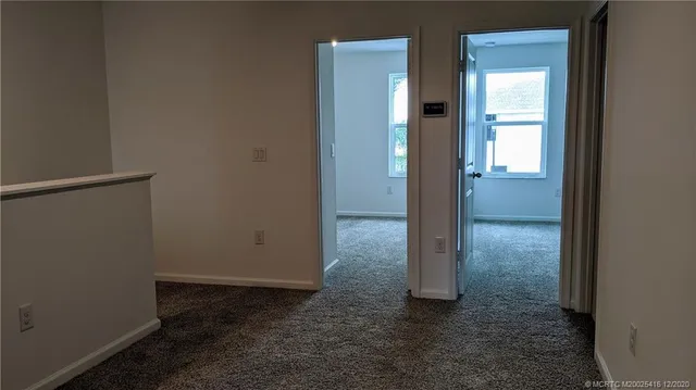 a large kitchen with stainless steel appliances kitchen island granite countertop a refrigerator and a stove top oven