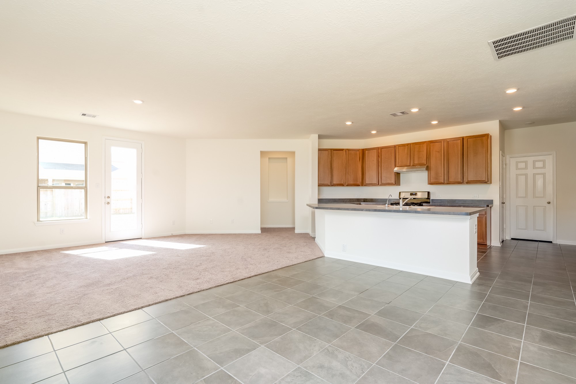 6120 Whitewing Road Rosenberg, TX 77469 - Photo 12 of 35 a view of kitchen with kitchen island and stainless steel appliances