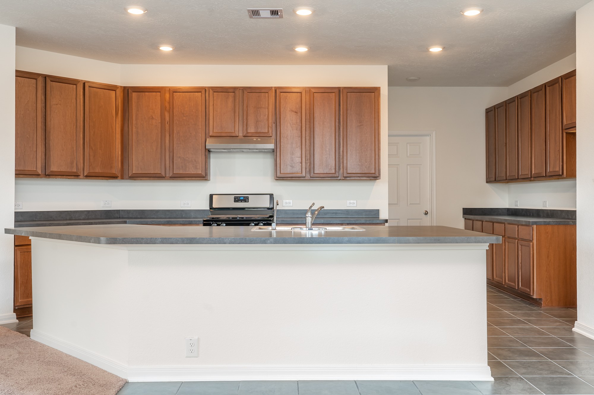 6120 Whitewing Road Rosenberg, TX 77469 - Photo 15 of 35 a kitchen with a sink and cabinets