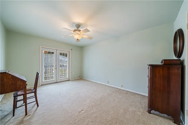 a view of room with workspace and windows