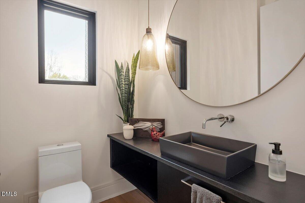 206 Dundas Lane Raleigh, NC 27603 - Photo 25 of 30 a bathroom with a toilet a sink and mirror