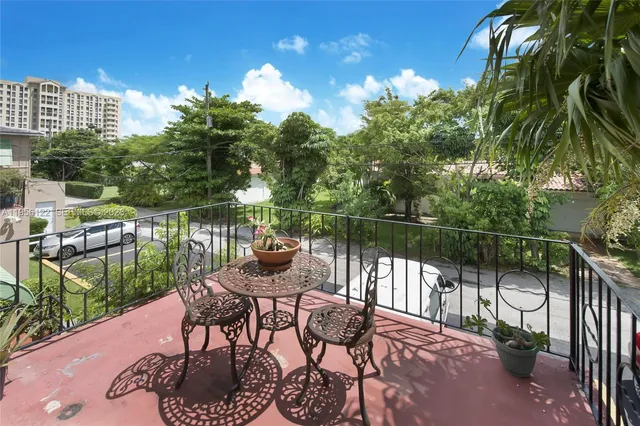 a view of a chairs and table in the balcony