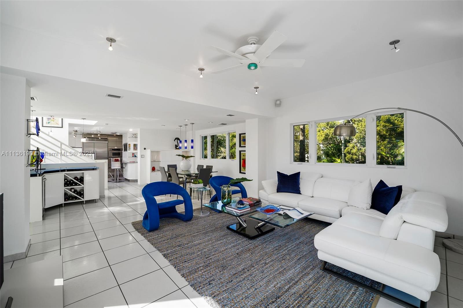 a living room with furniture and a floor to ceiling window