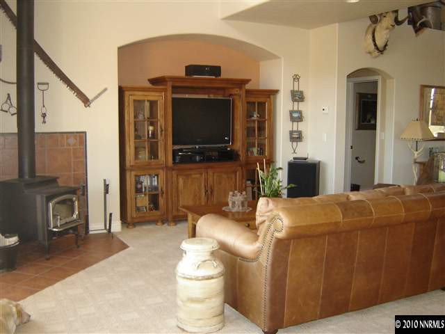 100 Antelope Valley Road Reno, NV 89506 - Photo 5 of 9 a living room with furniture a flat screen tv and a fireplace