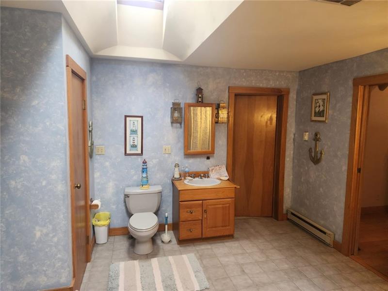222 Camelot Road Portersville, PA 16051 - Photo 11 of 16 a bathroom with a sink mirror vanity and toilet