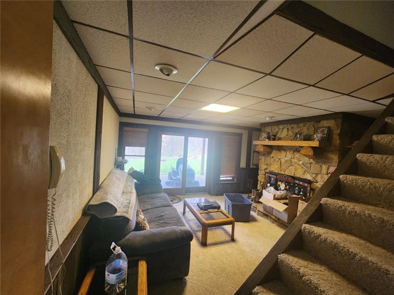 222 Camelot Road Portersville, PA 16051 - Photo 14 of 16 a living room with furniture and a fireplace