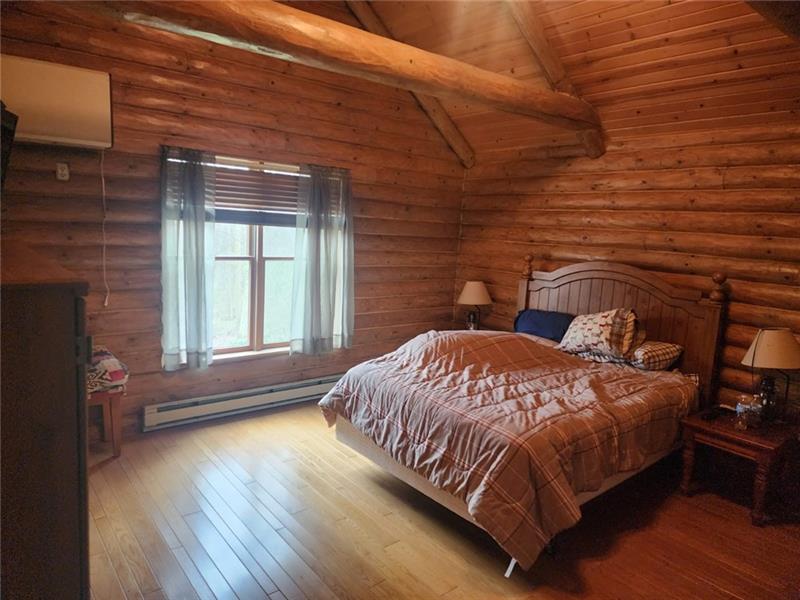 222 Camelot Road Portersville, PA 16051 - Photo 5 of 16 a bedroom with a bed and wooden floor