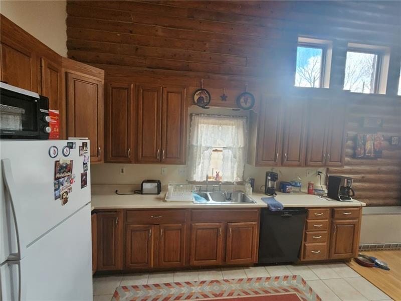 222 Camelot Road Portersville, PA 16051 - Photo 6 of 16 a kitchen with kitchen island granite countertop a sink cabinets and window