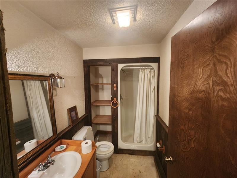 222 Camelot Road Portersville, PA 16051 - Photo 10 of 16 a bathroom with a granite countertop toilet sink and mirror