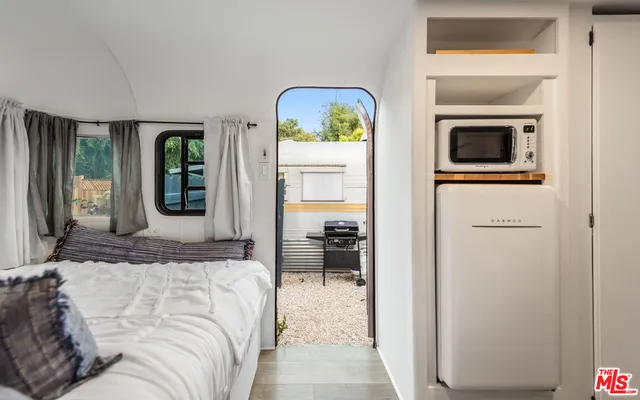 a bedroom with a bed and a painting on the wall