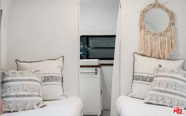 a en suite bathroom with a double vanity sink and a mirror