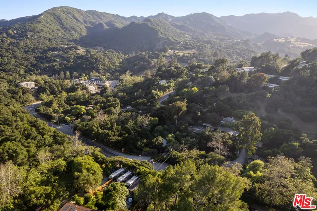 a view of a mountain range with lush green forest
