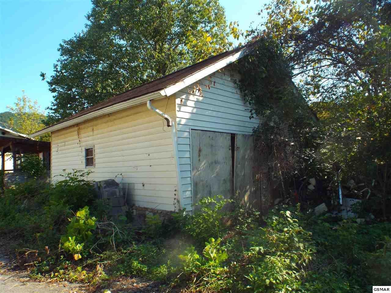 2364 Pittman Center Road Sevierville, TN 37876 - Photo 18 of 20 a view of a house with a yard and plants