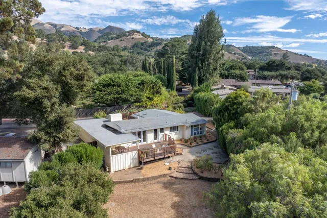 an aerial view of a house with yard swimming pool and mountain view