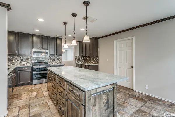 a kitchen with a stove a sink and a refrigerator