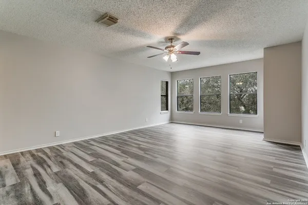wooden floor in an empty room with a window