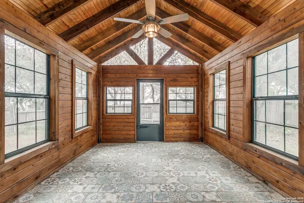 wooden floor in an empty room with a window