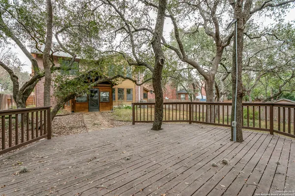 a view of a wooden deck with a large trees