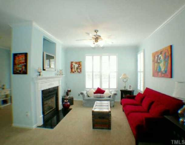 5934 Hourglass Court Raleigh, NC 27612 - Photo 7 of 10 The family room has crown molding, fireplace with gas logs and a tv nook. There is also a ceiling fan. Other