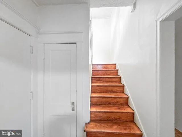 a view of staircase with white walls and a window
