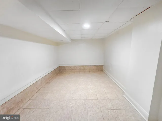 an empty room with a empty space and windows