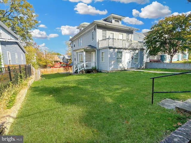 a view of a front of a house with a big yard
