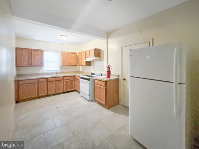 a kitchen with stainless steel appliances a refrigerator sink and cabinets