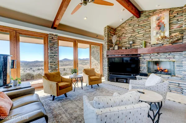 a view of a livingroom with furniture and a flat screen tv