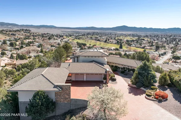 an aerial view of a house with a yard