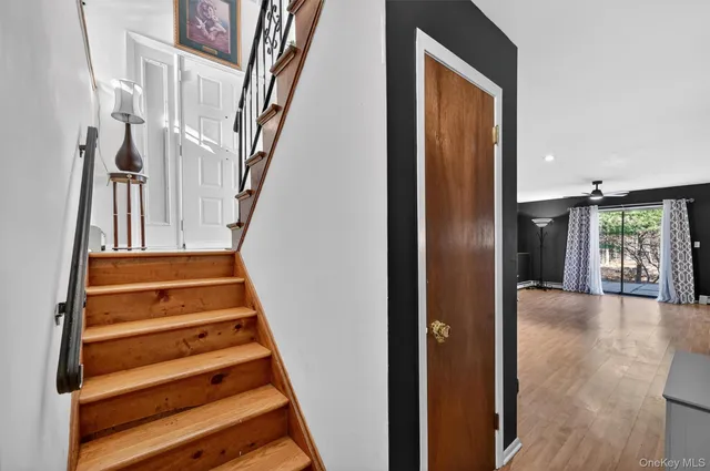 a view of entryway and hall with wooden floor