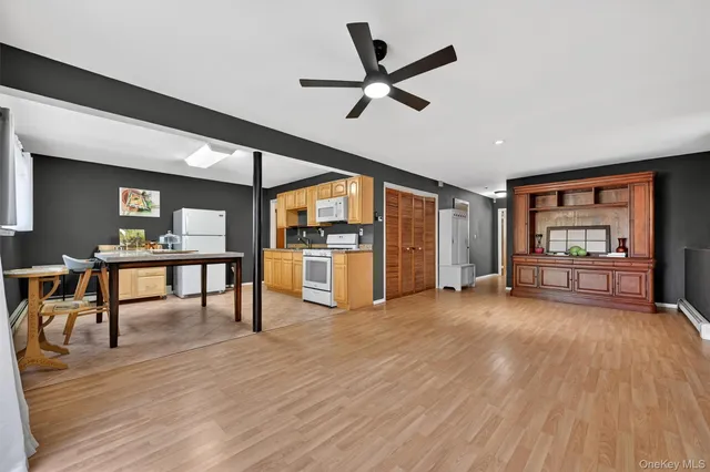 a view of a livingroom with furniture and a kitchen view