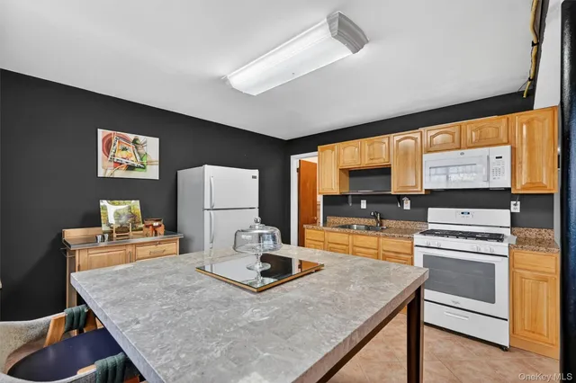 a kitchen with kitchen island a stove and a table