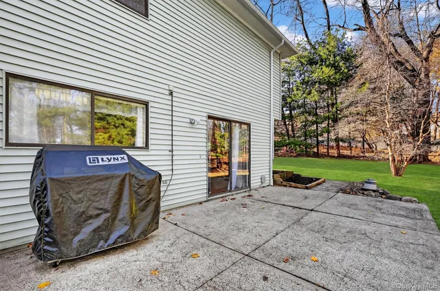 a view of a house with backyard and sitting area