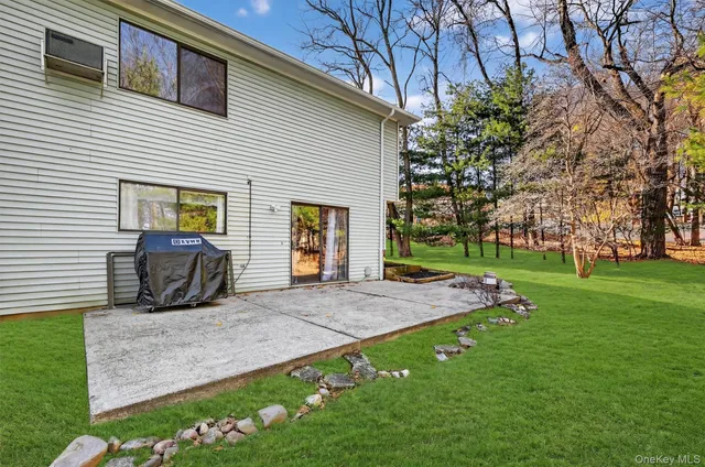 a front view of house with yard and green space