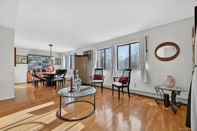 a living room with furniture and floor to ceiling window