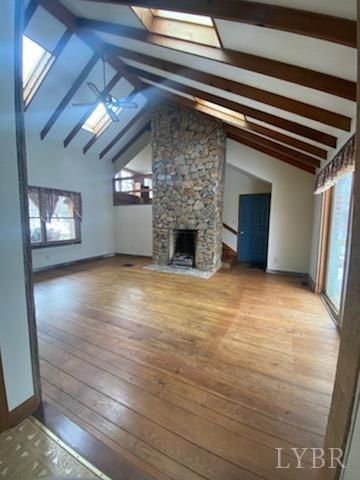 211 Snooty Fox Road Goode, VA 24556 - Photo 3 of 9 a view of empty room with wooden floor and fireplace