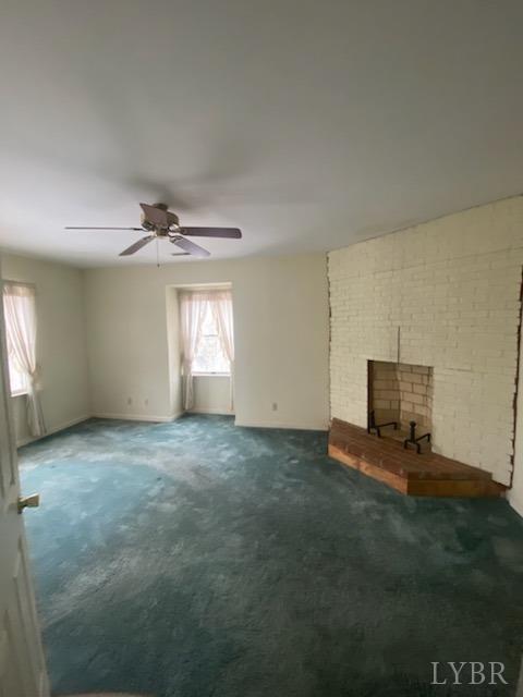 211 Snooty Fox Road Goode, VA 24556 - Photo 6 of 9 an empty room with windows and fireplace