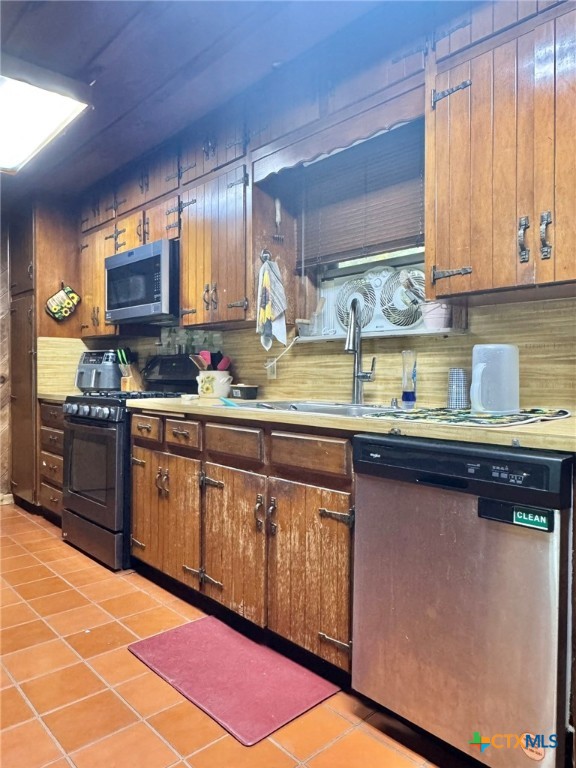 3221 West Ave R Temple, TX 76504 - Photo 16 of 48 a kitchen with stainless steel appliances granite countertop a sink stove and cabinets