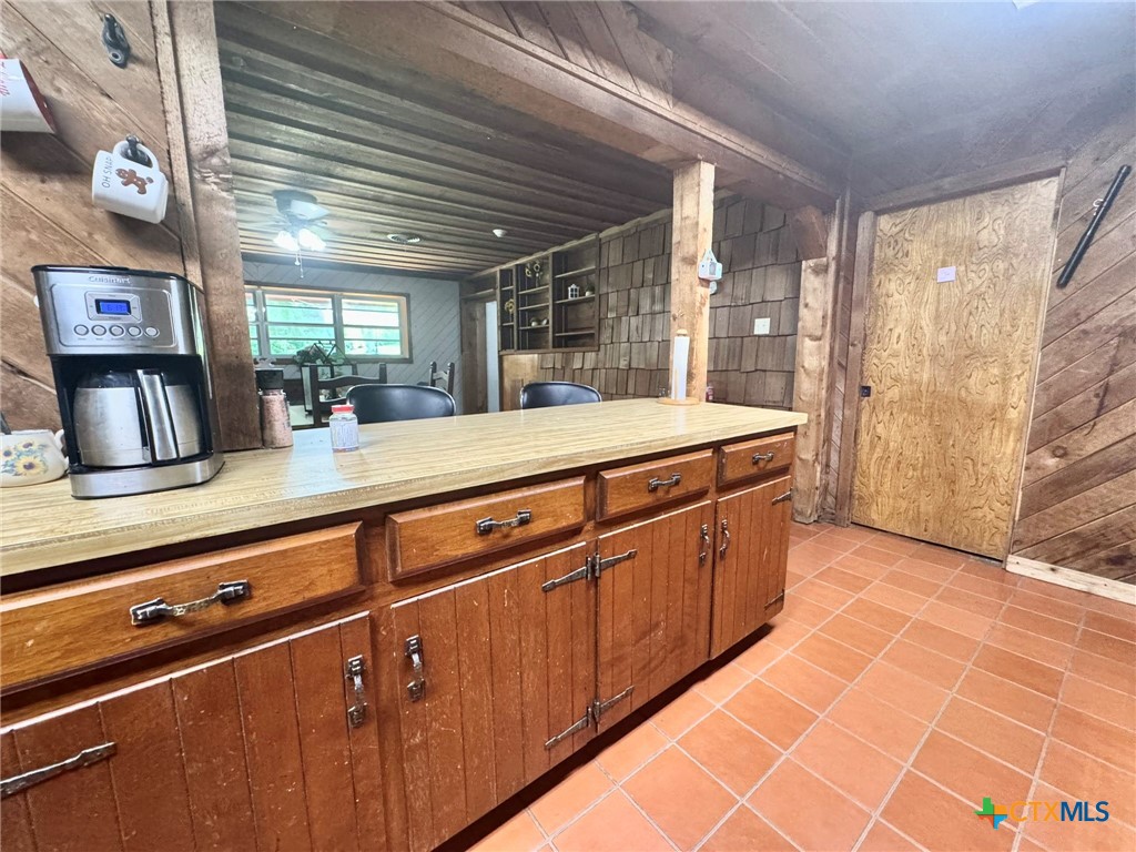 3221 West Ave R Temple, TX 76504 - Photo 17 of 48 a kitchen with stainless steel appliances kitchen island granite countertop a sink and cabinets