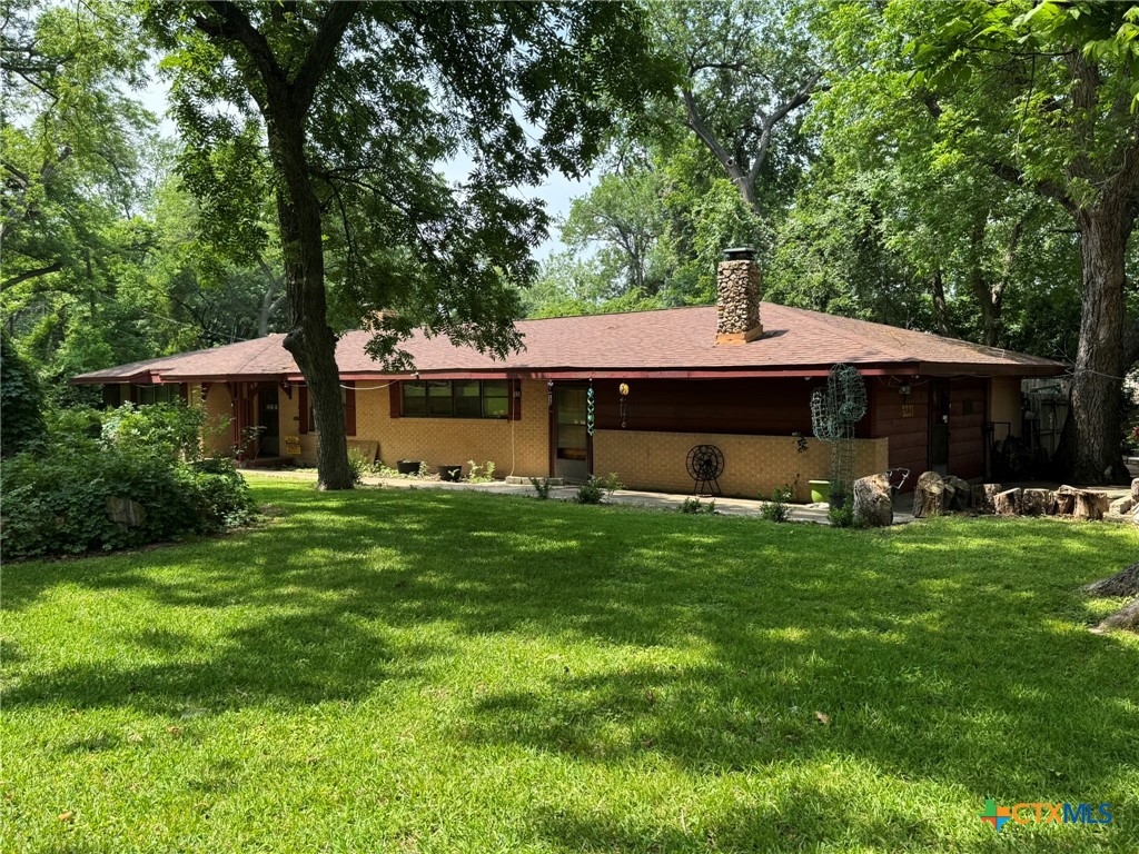 3221 West Ave R Temple, TX 76504 - Photo 2 of 48 a front view of a house with a garden