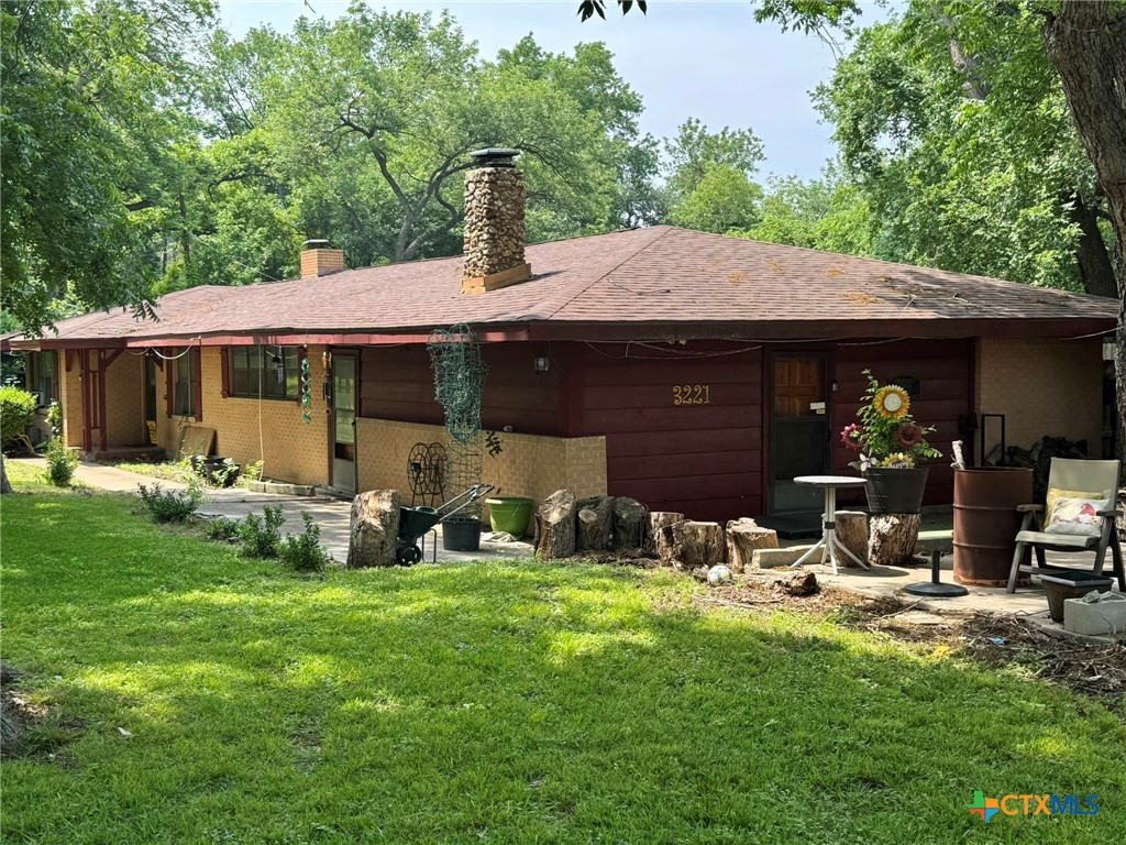 3221 West Ave R Temple, TX 76504 - Photo 3 of 48 a view of a house with backyard sitting area and garden