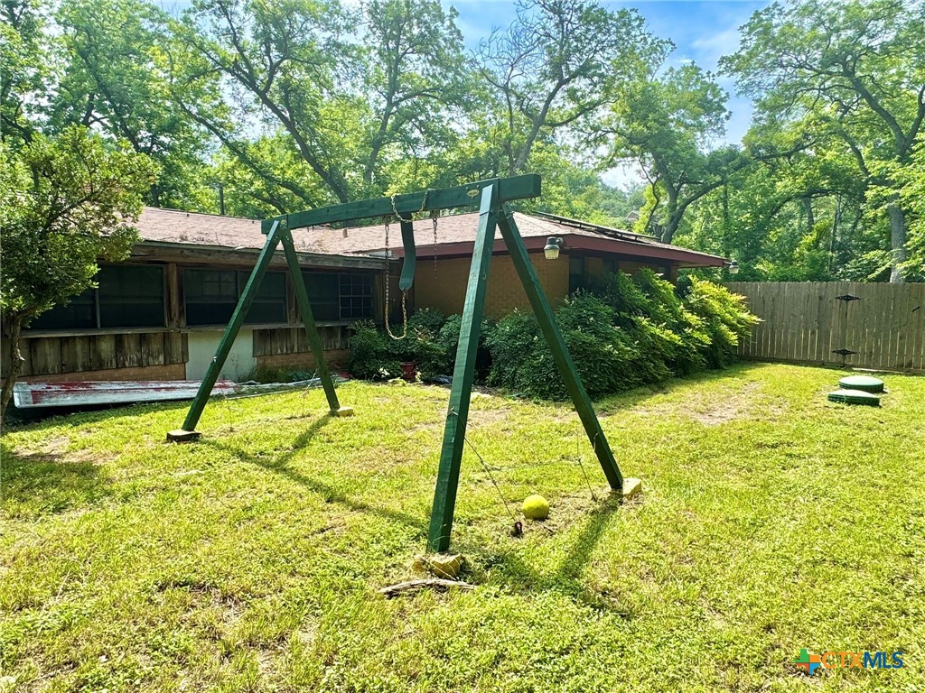 3221 West Ave R Temple, TX 76504 - Photo 34 of 48 a view of backyard with a slide